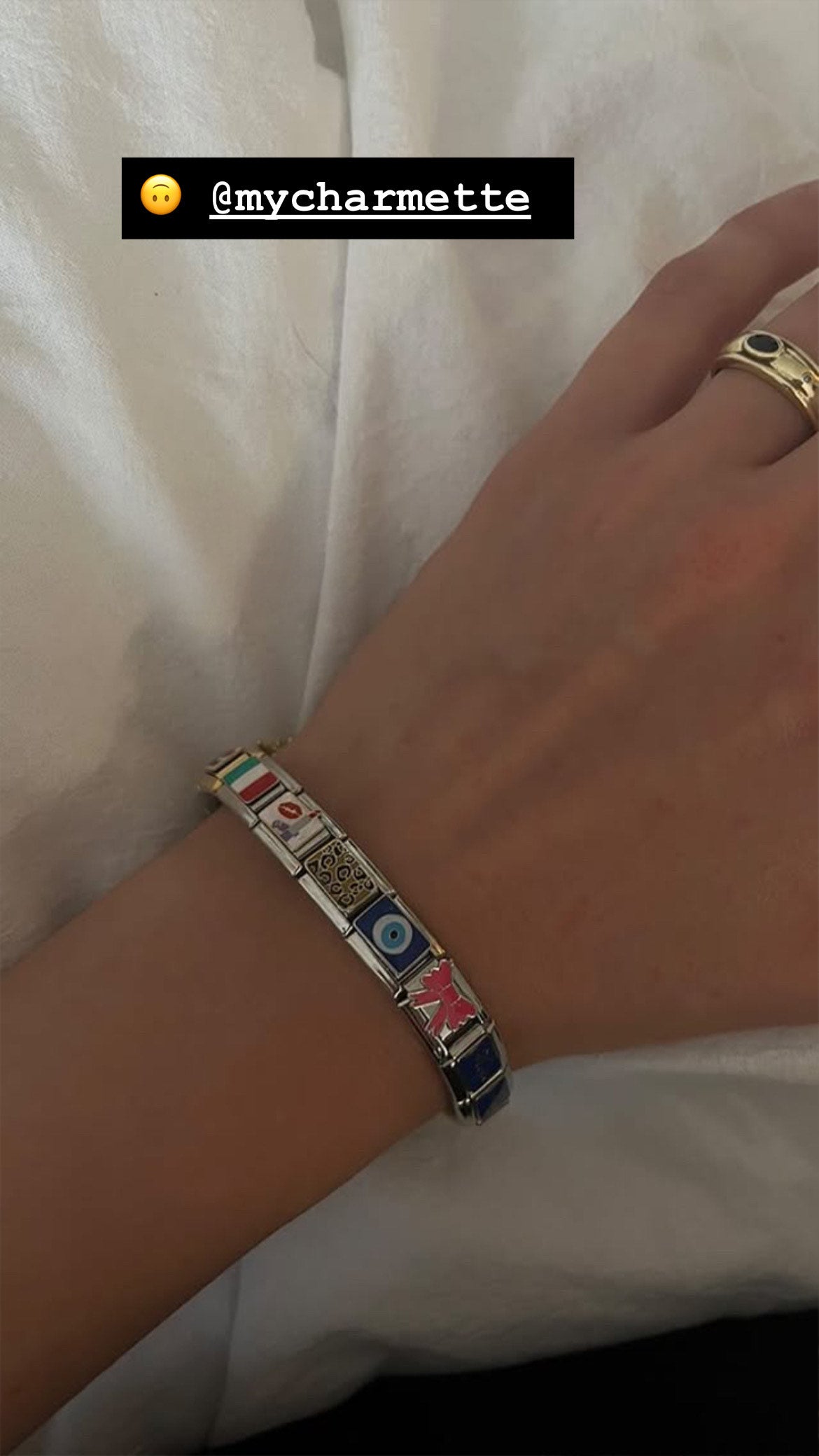 custom italian charm bracelet worn on wrist at cafe